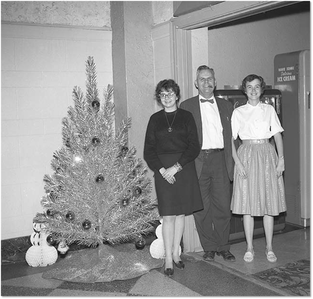 Night staff pose next to Retlaw Christmas tree